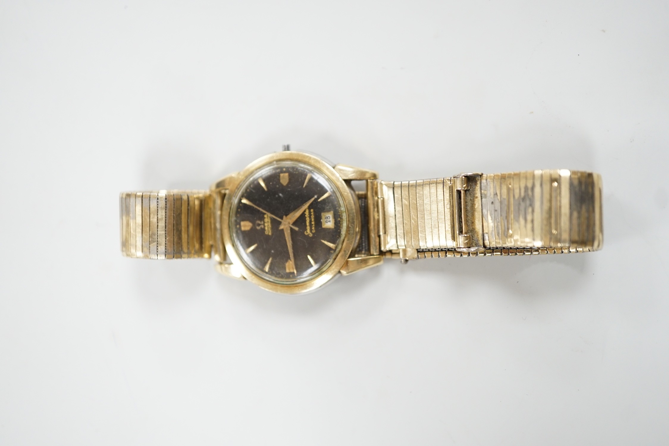 A gentleman's steel and gold plated Omega Seamaster Calendar automatic black dial wrist watch, case diameter 35mm, lacking winding crown, on associated bracelet.